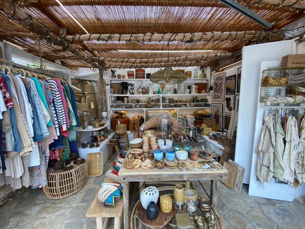 Warm interior of a small independent shop with handmade goods arranged on wooden shelves
