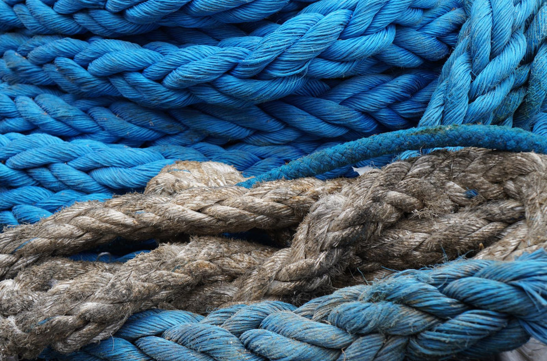 Close up of coiled blue and rustic climbing rope, the raw material for handmade Forma belts and gifts