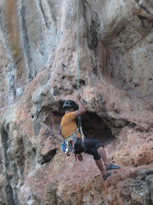 Man rock climbing on a rocky cliff face outdoors