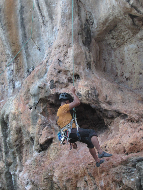 Man rock climbing on a rocky cliff face outdoors