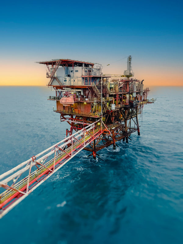 Offshore oil rig at sunset seen from above