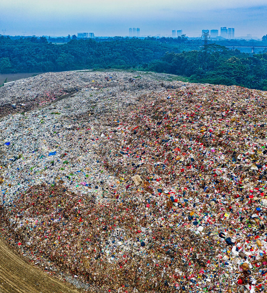 A landfill site piled with buried waste, where binned nylon climbing rope ends up