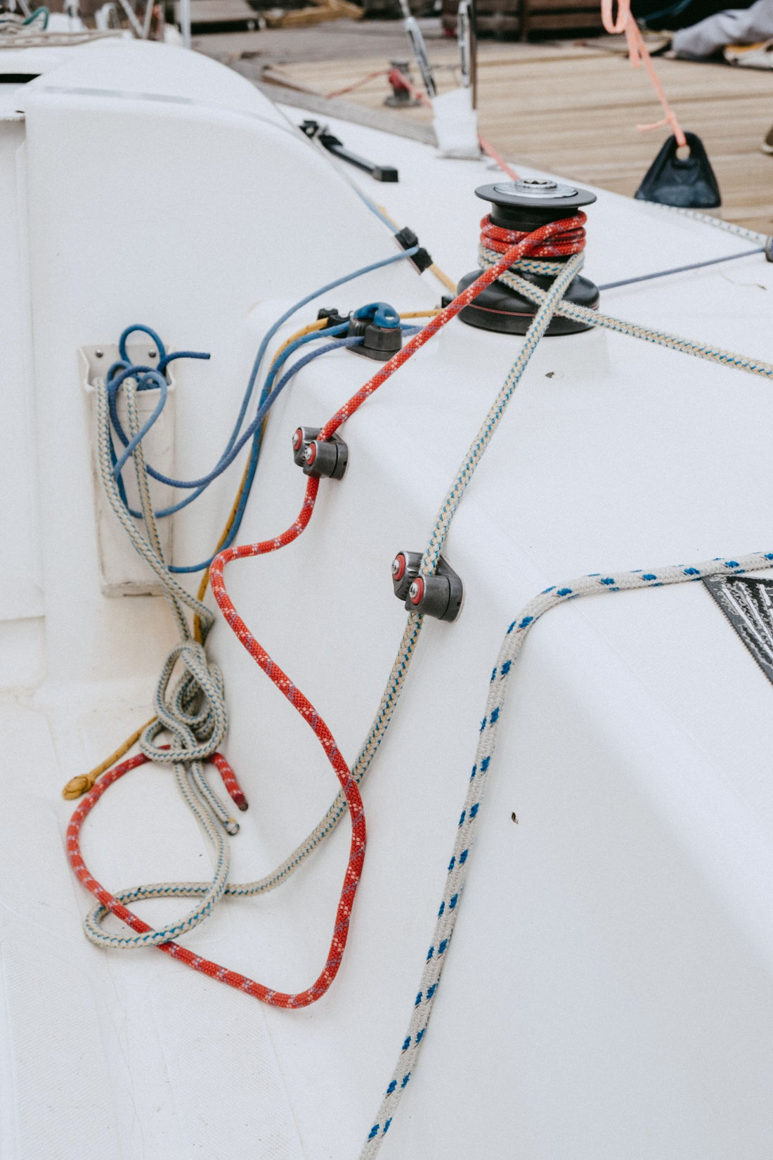 Nautical ropes and deck hardware coiled on a yacht deck