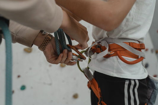 Close-up of a climbing harness and ropes laid out ready for indoor climbing