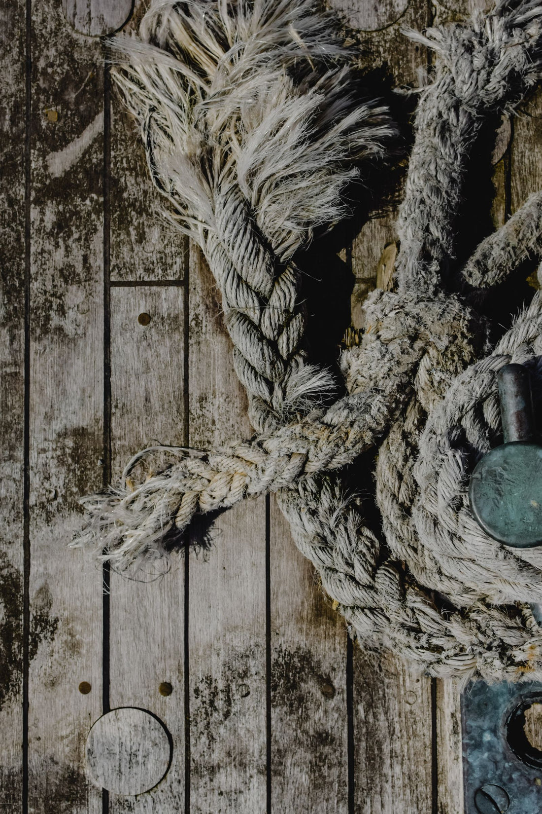 Close-up of a rope lying on a wooden surface