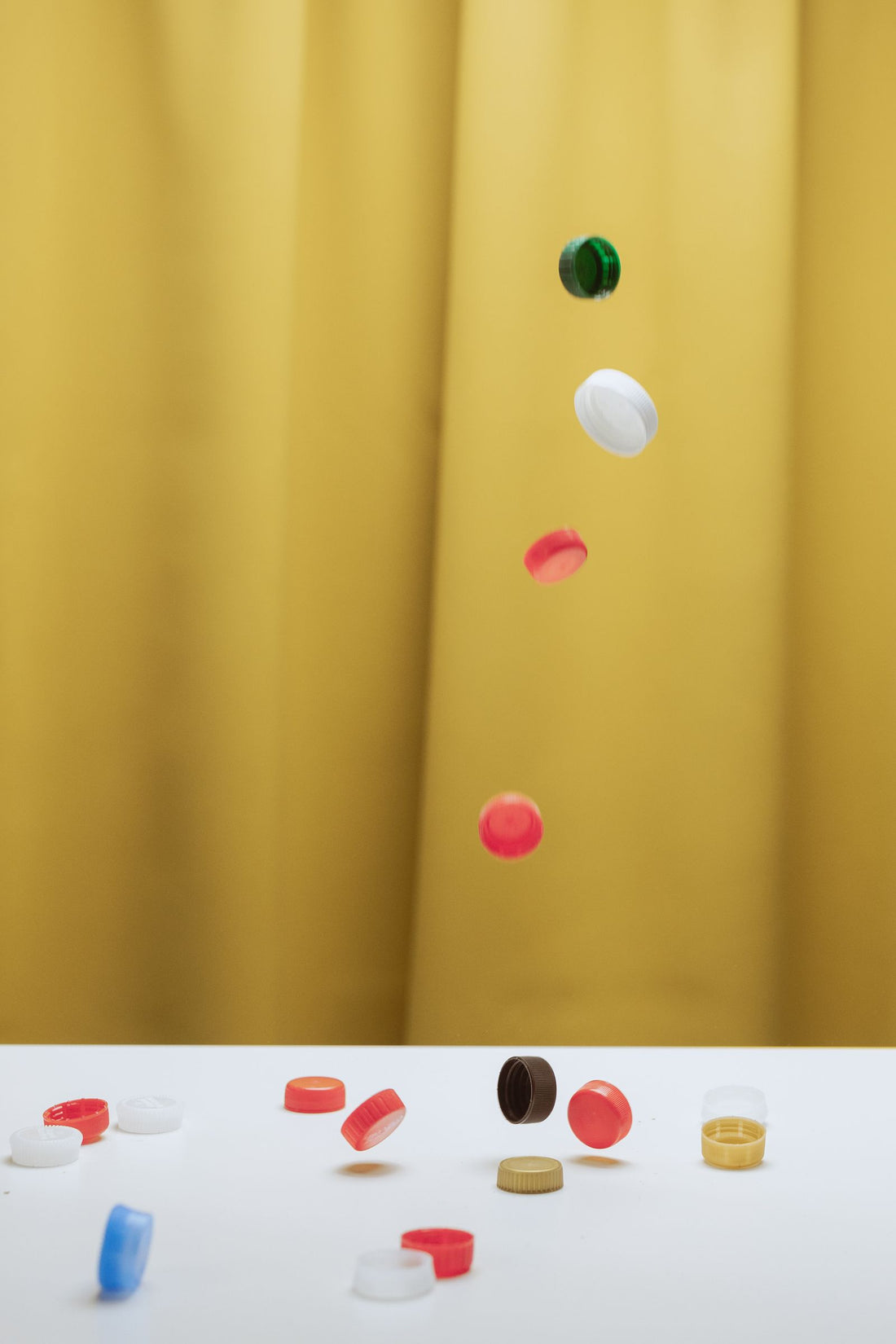Colourful plastic bottle caps scattered on a table