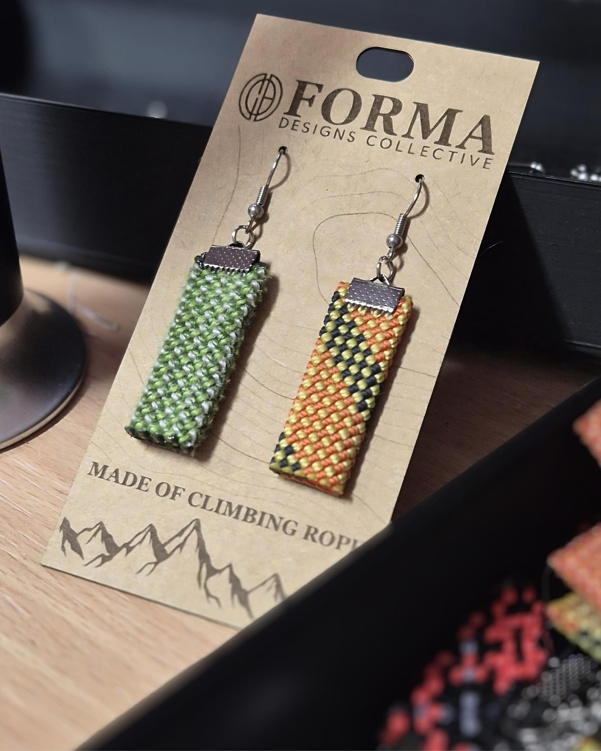 Climbing rope earrings in warm and cool colour options laid side by side
