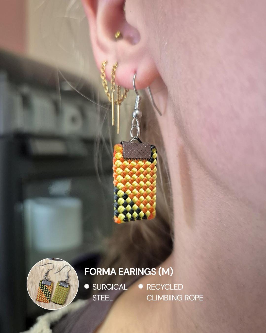 Pair of earrings made from recycled climbing rope, held in a hand