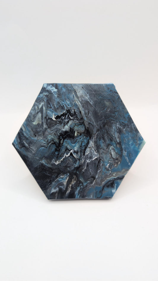 Hexagon coaster made from recycled plastic bottle lids, marbled blue and black Midnight colourway