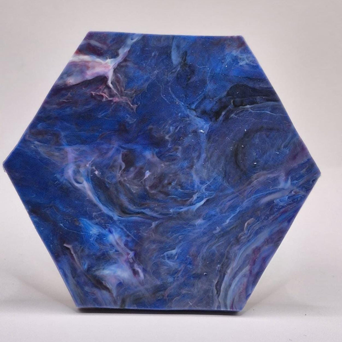 Recycled plastic hexagon coaster showing the natural cork base